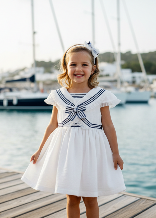 Basmarti Sailor girls navy and white dress by the beach