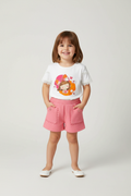 Little girl wearing character t-shirt with pink shorts
