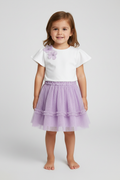 Little girl wearing flower t-shirt with lavender tulle skirt