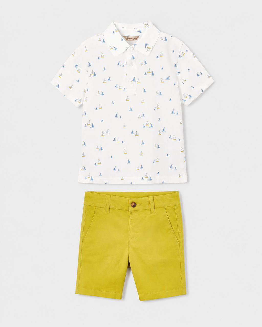 Flat lay of the Mayoral white boat-print polo shirt and Capri-yellow chino shorts outfit