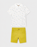 Flat lay of the Mayoral white boat-print polo shirt and Capri-yellow chino shorts outfit