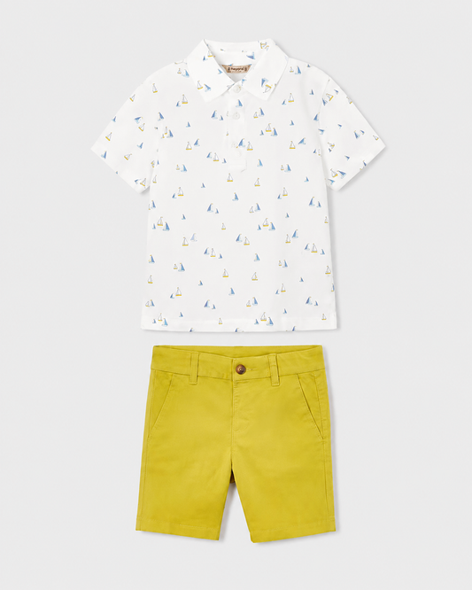 Flat lay of the Mayoral white boat-print polo shirt and Capri-yellow chino shorts outfit