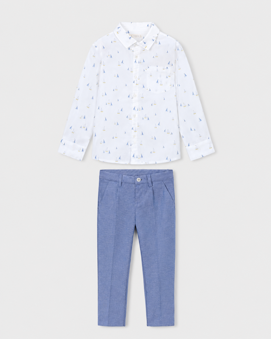 Flat lay of the Mayoral white boat-print shirt and Capri-blue trousers outfit
