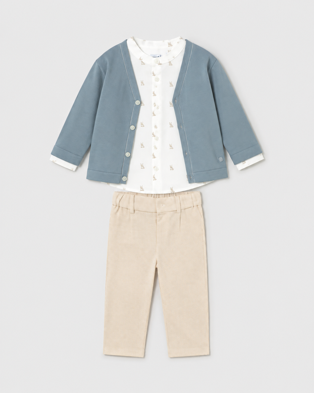 Flat lay of the Mayoral jade cardigan, ivory printed shirt and beige checked trousers outfit
