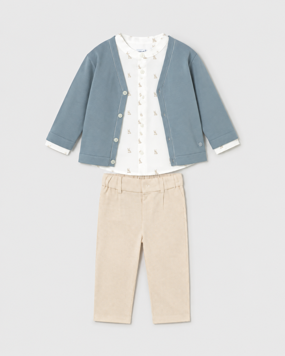 Flat lay of the Mayoral jade cardigan, ivory printed shirt and beige checked trousers outfit