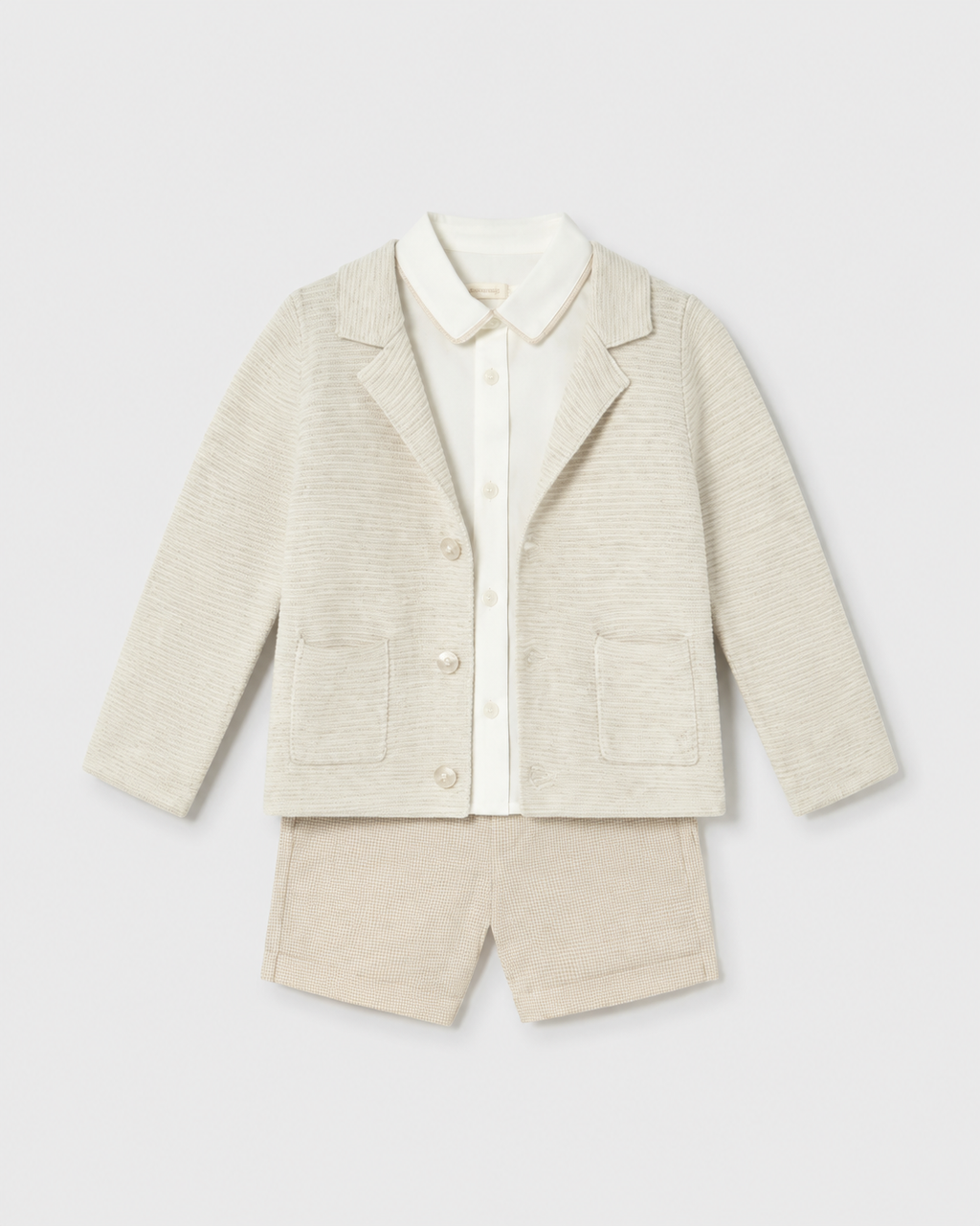 Flat lay of the Mayoral long-sleeved oat cardigan, ivory shirt and checked shorts outfit