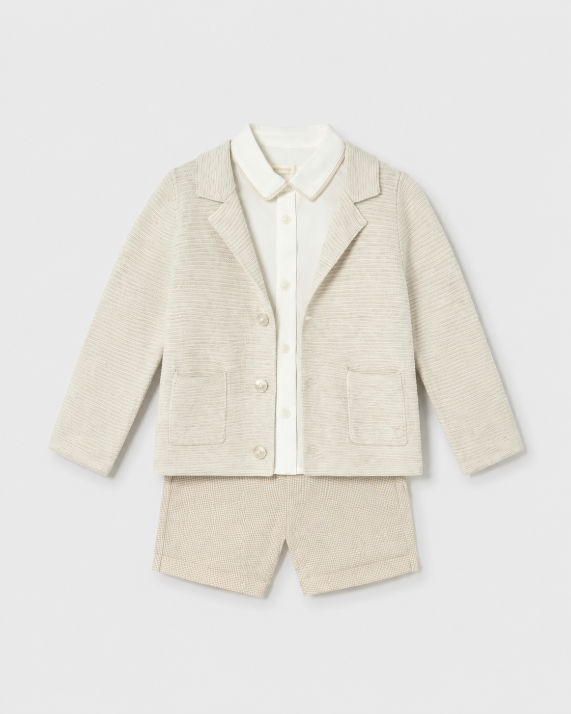 Flat lay of the Mayoral long-sleeved oat cardigan, ivory shirt and checked shorts outfit