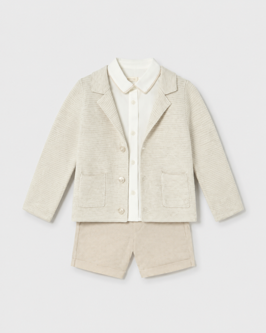Flat lay of the Mayoral long-sleeved oat cardigan, ivory shirt and checked shorts outfit