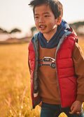 Boy wearing Mayoral red and grey reversible hooded gilet