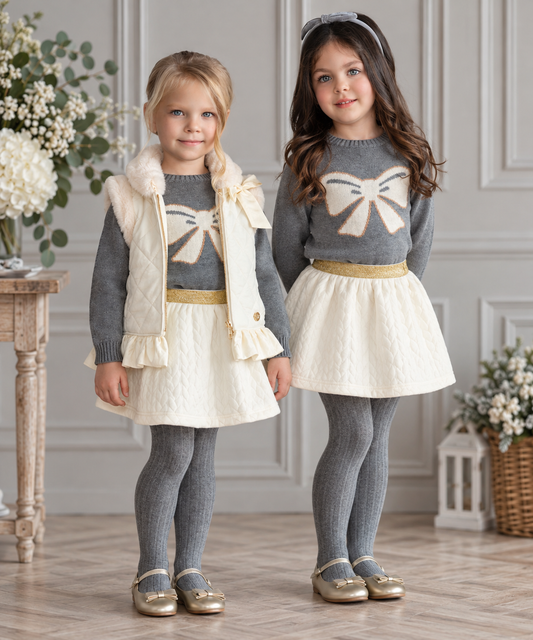 Girls wearing Miranda cream and grey bow knit skirt set with cream gilet