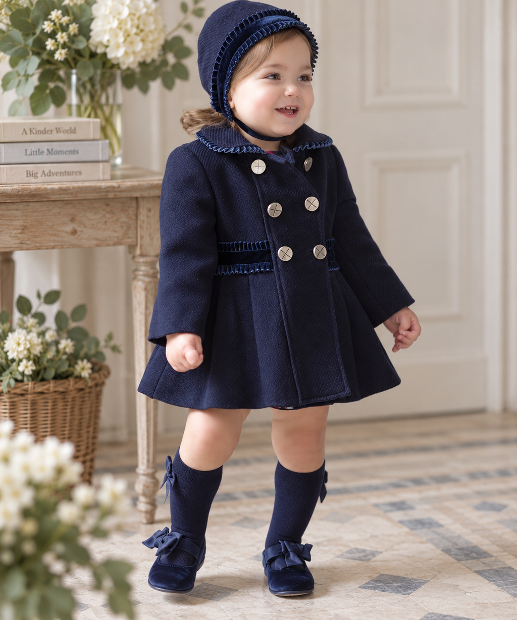 Baby girl wearing MIRANDA navy traditional coat and matching bonnet