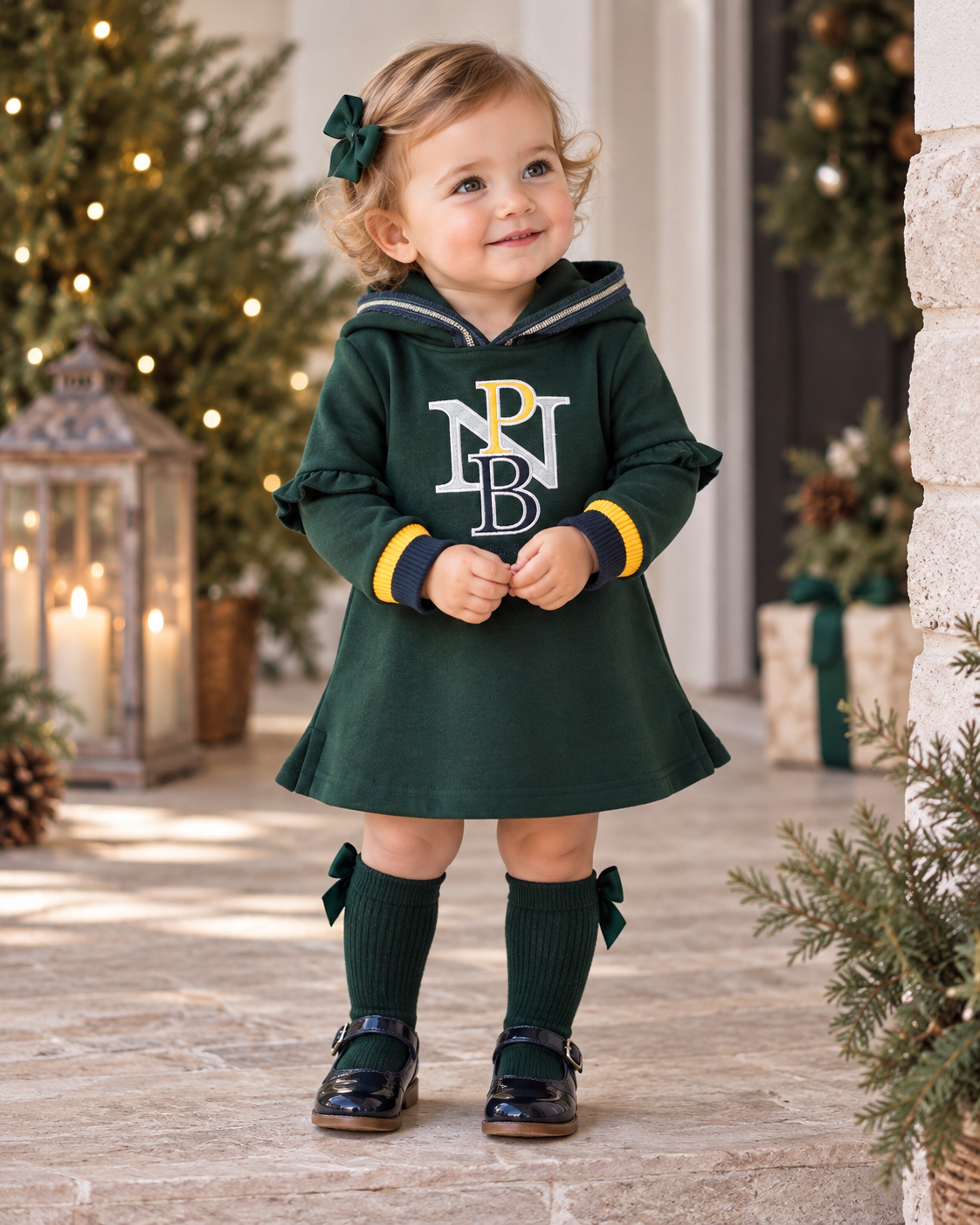 Baby girl wearing Miranda Nel Blu green hooded winter dress