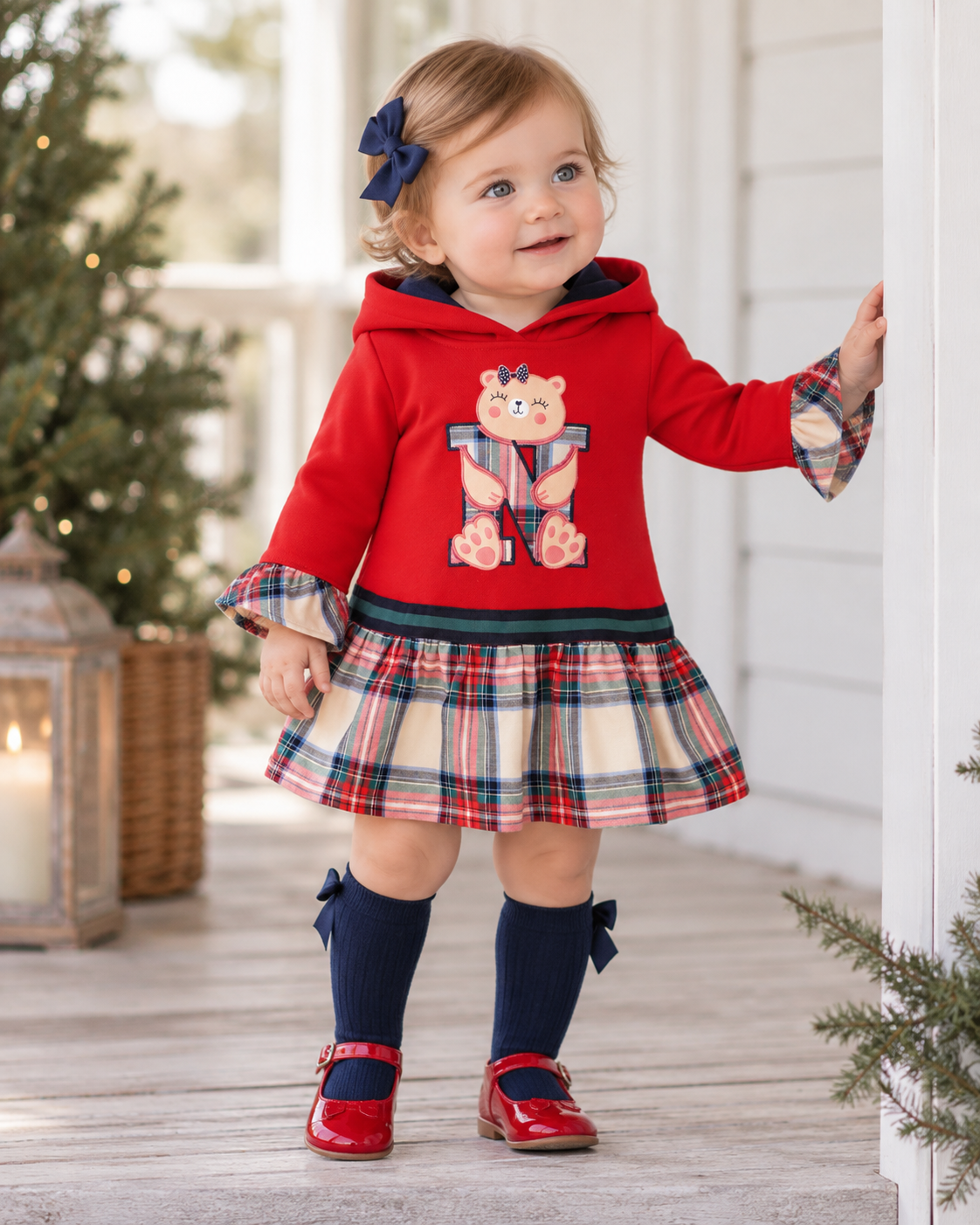Baby girl wearing Miranda Nel Blu red tartan hooded dress