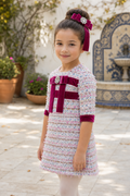 Close-up of the Naxos purple tweed A-line dress with velvet bow and jewelled trim