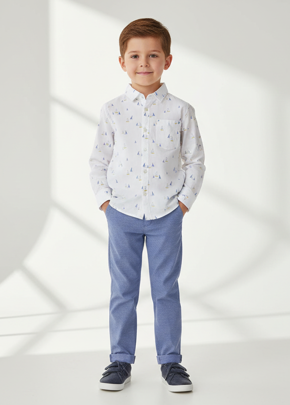 Boy wearing the Mayoral boat-print shirt with Capri-blue trousers