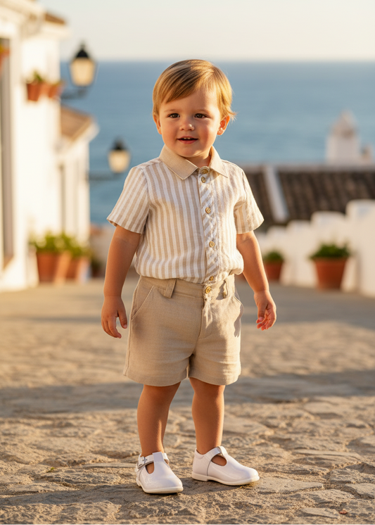 Basmarti Rayas boys beige stripe short set in a seaside setting