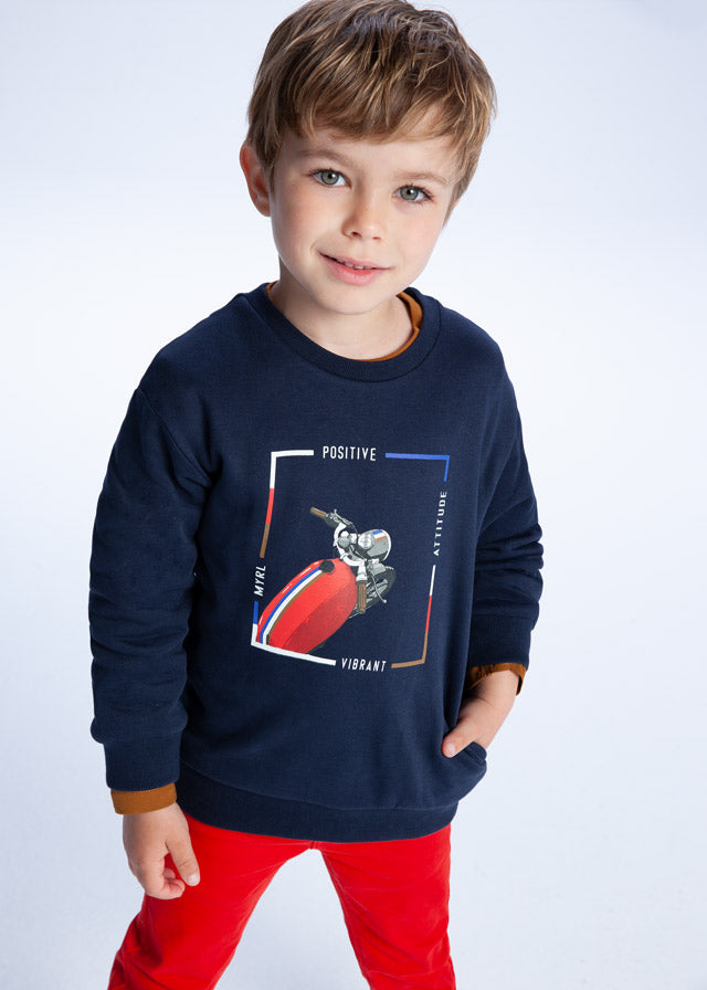Boy wearing Mayoral navy motorbike sweatshirt 4406 with red trousers